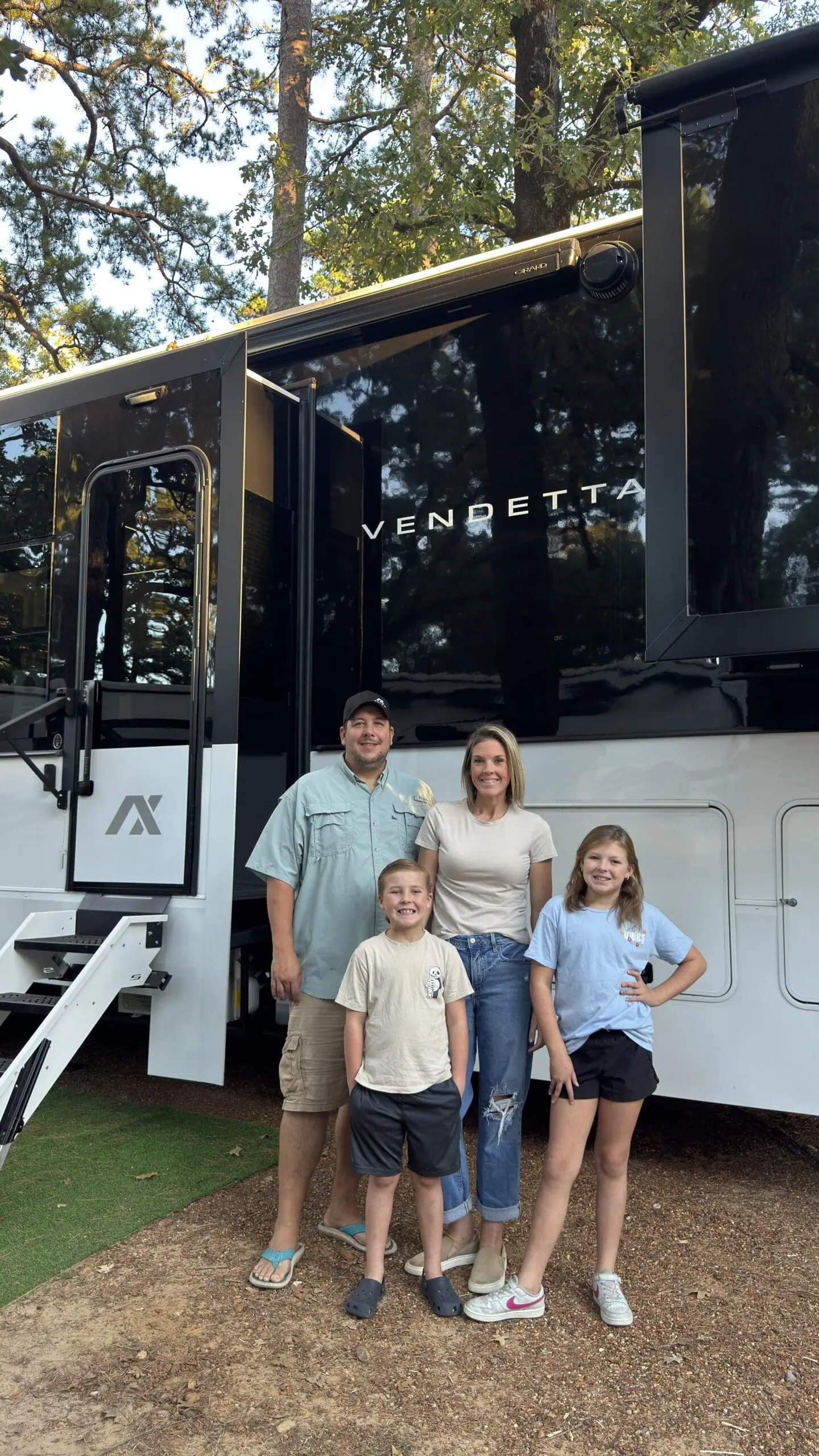 The Lawing family, a full-time RV family of four, beside their Axiom RV Vendetta 4250.