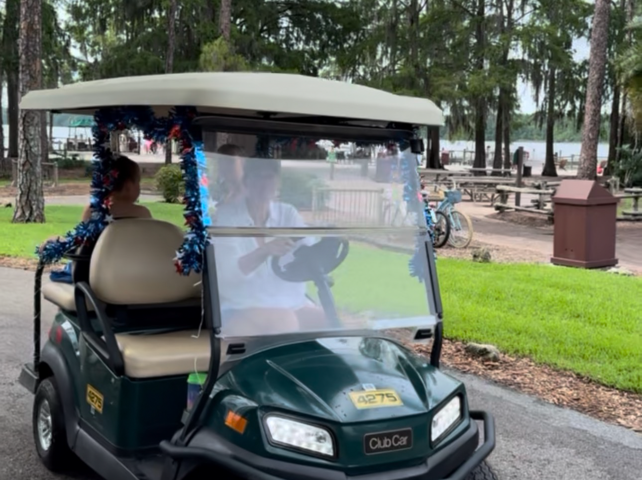 Family cruising through Fort Wilderness on a rented golf cart