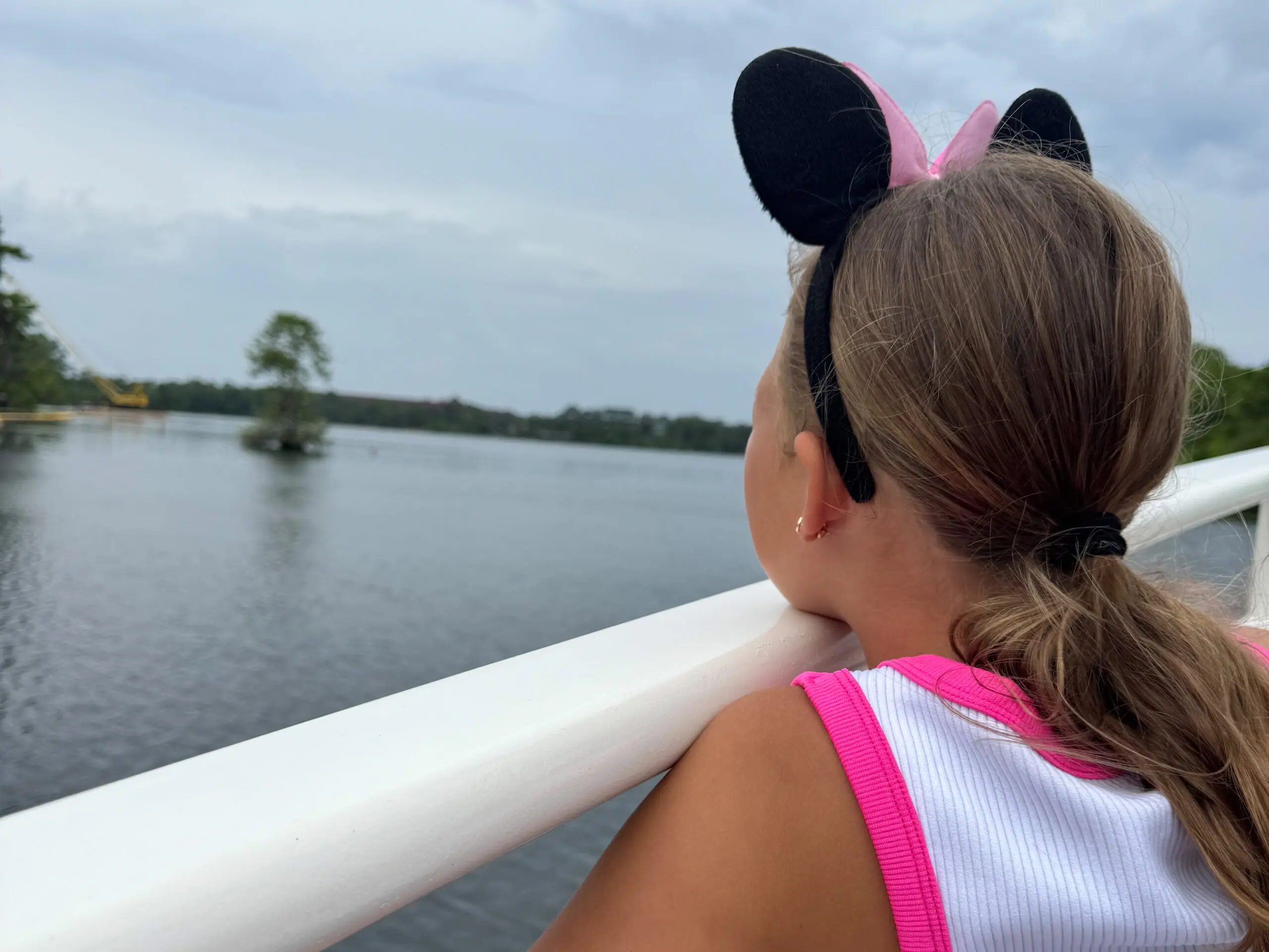 Skylar on the boat at Fort Wilderness with the lake in the background
