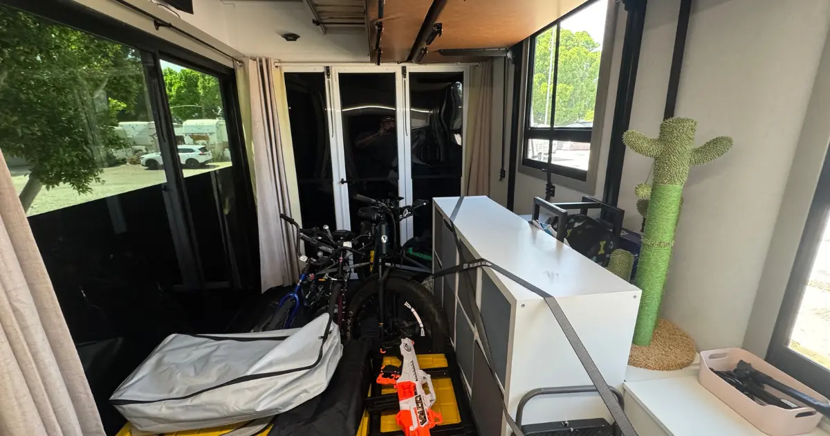 Bikes, scooters, and outdoor gear stored in the fifth wheel toy hauler garage bay instead of cluttering the main living area